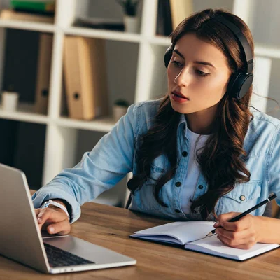 A student sits at a desk studying on a computer