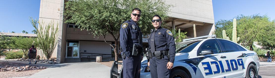 2 PCC police officers with police car